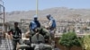 United Nations (U.N.) observers examine a Syrian army tank during a field visit to the al-Zabadani area, near Damascus, May 6, 2012. Al-Zabadani is one of the locations where protests against the regime of Syrian President Bashar al-Assad were being held.