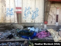 These bodies of IS militants were recently laid out in the street for pick-up under pro-Iraqi military graffiti on March 1, 2018 in Old Mosul, Iraq.