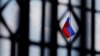 FILE - The Russian flag flies over the Embassy of Russia in Washington, Aug. 6, 2018.