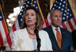 FILE - Speaker of the House Nancy Pelosi, D-Calif., joined at right by Senate Minority Leader Chuck Schumer, D-N.Y., calls for a Senate vote on the House-passed Bipartisan Background Checks Act at the Capitol in Washington, Sept. 9, 2019.