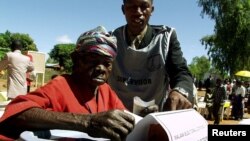 FILE - An elderly woman casts her vote in Malawi's general election in Machinga district, north of the commercial capital, Blantyre.