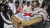 Pakistani hospital staff and rescue workers carry the coffin of British Red Cross worker Khalil Rasjed Dale to an ambulance, from a hospital in Quetta, Pakistan, April 30, 2012.