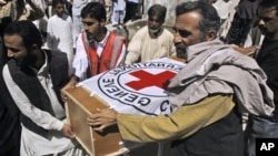 Pakistani hospital staff and rescue workers carry the coffin of British Red Cross worker Khalil Rasjed Dale to an ambulance, from a hospital in Quetta, Pakistan, April 30, 2012.