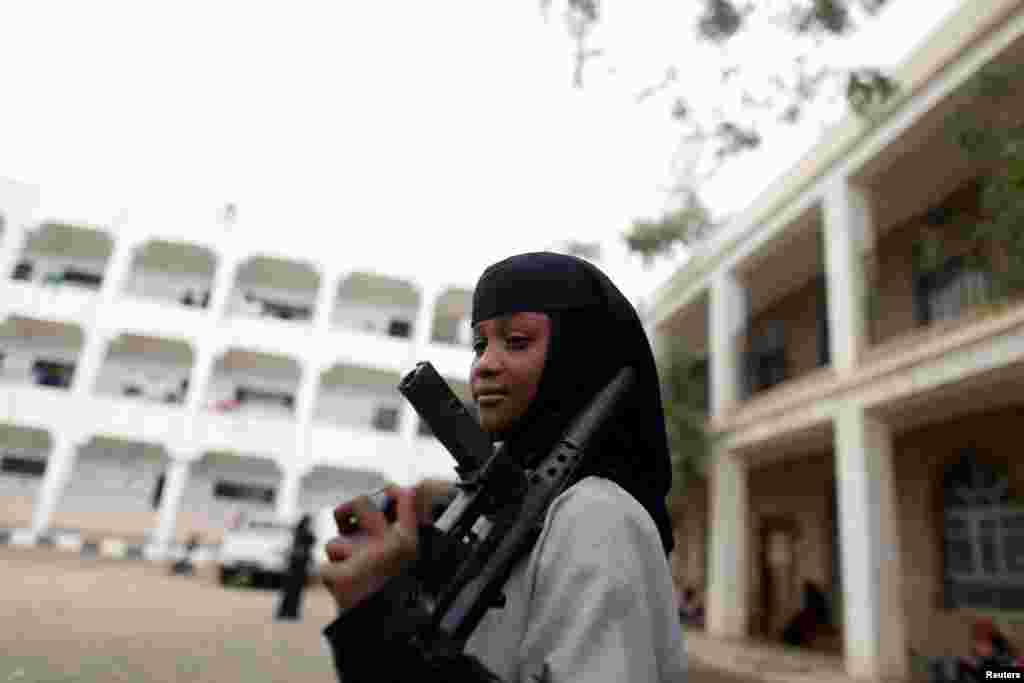 A girl displaced by the fighting in the Red Sea port city of Hodeidah holds a toy rifle at a school where IDPs live, in Sana'a, Yemen, June 26, 2018.