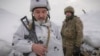 Ukrainian servicemen stand in a trench on the front line in the Luhansk area, eastern Ukraine, Jan. 27, 2022.