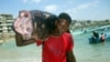 A Somali fisherman carries a fish called "Yapuri" as he walks from Hamarweyne beach in Mogadishu, Somalia, November 22, 2008. 