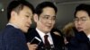 FILE - Jay Y. Lee (center) vice chairman of Samsung Electronics, arrives to be questioned as a suspect in bribery case in the influence-peddling scandal that led to the president's impeachment at the office of the independent counsel in Seoul, South Korea, Jan. 12, 2017. 