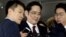 FILE - Jay Y. Lee (center) vice chairman of Samsung Electronics, arrives to be questioned as a suspect in bribery case in the influence-peddling scandal that led to the president's impeachment at the office of the independent counsel in Seoul, South Korea, Jan. 12, 2017. 