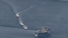 FILE - This photo obtained from the U.S. Navy on April 15, 2020, shows Iranian Islamic Revolutionary Guard Corps Navy vessels conducting what the U.S. said were unsafe actions against U.S. military ships, in international waters of the Persian Gulf.