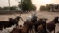 FILE - A man leads his herd of cattle in Maroua, Cameroon.