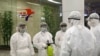 State Commission of Quality Management staff in protective gear and wielding disinfectant prepare to check the health of travelers arriving from abroad at the Pyongyang Airport in Pyongyang, North Korea, Feb. 1, 2020.
