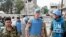 The Chief of the U.N. Supervision Mission to Syria, Norwegian Major General Robert Mood (2nd R) and his team walk with members of the Free Syrian Army, at the Khalidiya neighborhood during the United Nations observers' visit to Homs, May 3, 2012.