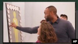 This image made from the National Academy of Sciences website on Oct. 2, 2019, shows part of a video of people discussing gene editing and designer babies.