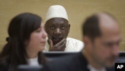 Congolese warlord Thomas Lubanga, center, awaits his verdict in the courtroom of the International Criminal Court in The Hague, Netherlands, March 14, 2012. 