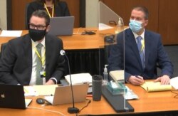 In this image from video, defense attorney Eric Nelson, left, and defendant former Minneapolis police Officer Derek Chauvin, listen, April 5, 2021, in the trial of Chauvin at the Hennepin County Courthouse in Minneapolis.