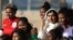 Nobel Peace Prize winner Malala Yousafzai is pictured with teenage girls from Complexo da Penha, who work with football organization Street Child United, at Copacabana beach in Rio de Janeiro, Brazil July 11, 2018.