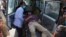 A man who was injured in a deadly suicide bombing that targeted a training class in a private building in the Shiite neighbourhood of Dasht-i Barcha, is placed in an ambulance in western Kabul, Afghanistan, Wednesday, Aug. 15, 2018. 