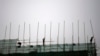 Laborers work at a construction site in Beijing, April 16, 2014. 