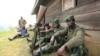 M23 rebel fighters rest at their defense position in Karambi, eastern Democratic Republic of Congo (DRC) in north Kivu province, near the border with Uganda, July 12, 2012. 