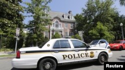 A U.S. Secret Service police car passes by the Syrian Embassy in Washington