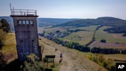 A former East German watch tower stands on a hill high above the former border area between East and West Germany in Unterweid, eastern Germany, Sept. 21, 2020.