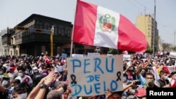 People react after Peru's interim President Manuel Merino announced his resignation, in Lima, Peru, Nov. 15, 2020.