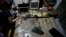 FILE - Members of the National Bureau of Investigation and FBI gather evidence at the home of an American suspected child webcam cybersex operator during a raid in Mabalacat, Philippines. 