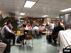 People wait for their flights at the departure lounge at the Toussaint Louverture airport in Port-au-Prince. (S. Lemaire/VOA)