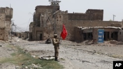 FILE - A Pakistani army soldier stands guard in Miranshah bazaar after driving out militants from Pakistan's tribal region of North Waziristan along the Afghanistan border, July 9, 2014.