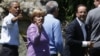 U.S. President Barack Obama, Germany's Chancellor Angela Merkel and French President Francois Hollande (L to R) face the media as the G8 leaders gather for a family photo at the G8 Summit at Camp David, Maryland, May 19, 2012