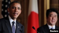 An employee of an environmental protection and coastal cleanup organization shows a figurine of South Korean singer Psy found during a search for debris from the ill-fated Malaysia Airlines flight MH370 on a beach in Sainte-Marie de la Reunion, between Champ Borne and the Rivière du Mât river, on the French Reunion Island in the Indian Ocean.