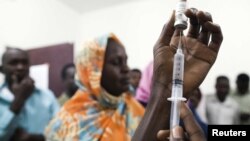 Staff members of the Teaching Hospital receive the first vaccination treatment for yellow fever in El Geneina, West Darfur, November 14, 2012 handout.