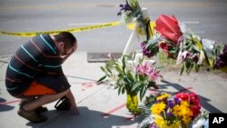 在南卡罗来纳州教堂枪击案出事地点附近的临时追悼场所，有人哀悼（2015年6月18日）