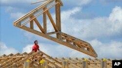 File - Construction workers build a commercial complex in Springfield, Illinois.