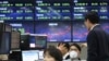 A currency trader wears a face mask at the foreign exchange dealing room of the KEB Hana Bank headquarters in Seoul, South Korea, Feb. 24, 2020. 