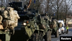FILE - A convoy of U.S. troops, a part of NATO's reinforcement of its eastern flank, drive from Germany to Orzysz in northeast Poland, March 28, 2017. 