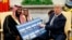 President Donald Trump shows a chart highlighting arms sales to Saudi Arabia during a meeting with Saudi Crown Prince Mohammed bin Salman in the Oval Office of the White House, Tuesday, March 20, 2018, in Washington.