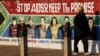 In this photo taken Tuesday April 14, 2009 a pedestrian passes an AIDS education billboard in Johannesburg. (AP Photo/Denis Farrell-File)