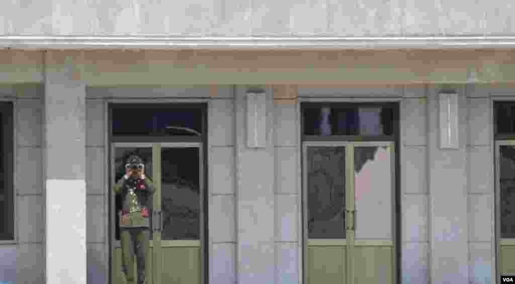 A North Korean soldier peering into South Korea in the Joint Security Area, April 17, 2013. (VOA/S. Herman)