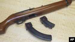 FILE - A semi-automatic rifle is displayed with a 25-shot magazine, left, and a 10-shot magazine, right, at a gun store in Elk Grove, Calif., June 27, 2017. 