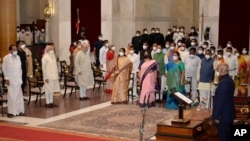  Indian Prime Minister Narendra Modi, third left in front row, and other senior ministers during swearing in ceremony at the Presidential Palace in New Delhi, India, July 7, 2021. 