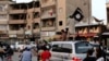 FILE - Members loyal to the Islamic State in Iraq and the Levant wave flags as they drive around Raqqa, June 29, 2014.