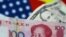 FILE - U.S. dollar and China yuan notes are seen in this illustration, June 2, 2017. This June, the yuan is set for its biggest monthly fall on record.