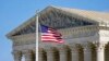 FILE - An American flag waves in front of the Supreme Court building on Capitol Hill in Washington, Nov. 2, 2020.