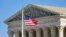 FILE - An American flag waves in front of the Supreme Court building on Capitol Hill in Washington, Nov. 2, 2020.