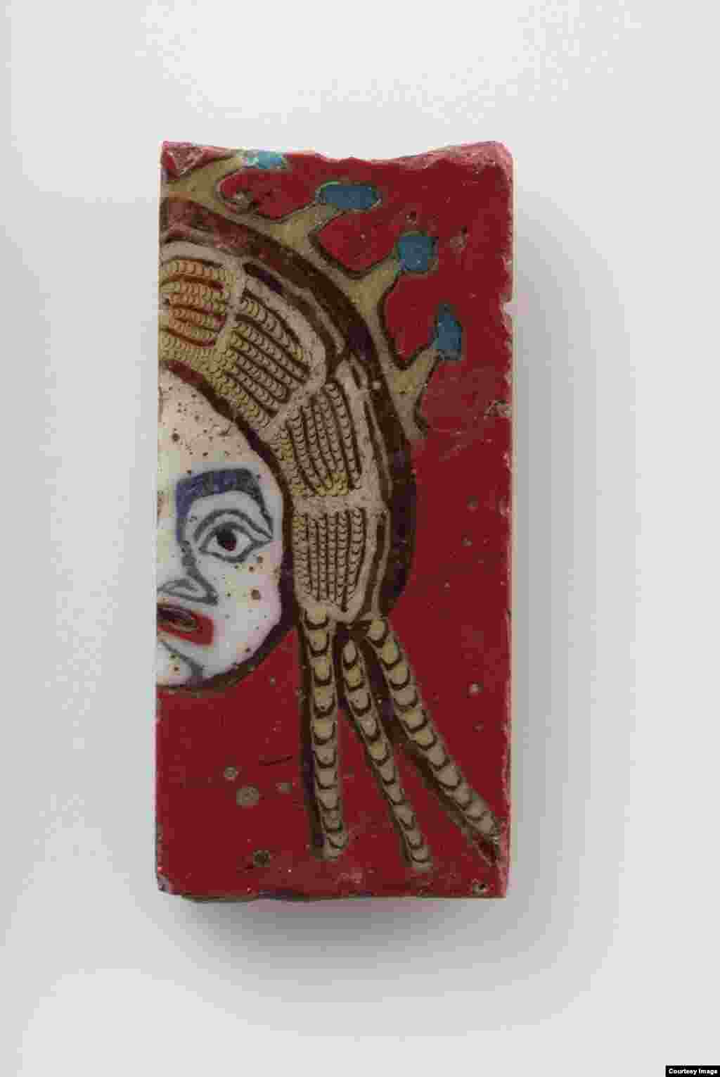 Tablet with the right half of a female mask, made from glass, Egyptian (305 B.C.E.-14 C.E.), Roman Period. 