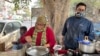 Anita Singh operates a food cart in New Delhi, but there are few customers as the city shutters partially. (Anjana Pasricha/VOA)