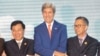 Vietnam Foreign Minister Pham Binh Minh (L), U.S. Secretary of State John Kerry (C), and an unidentified delegate from Malaysia, pose for a group photo as they shake hands during the ASEAN-U.S., on July 25, 2016.