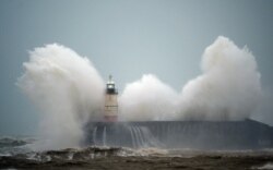 Waves crash over Newhaven Lighthouse on the south coast of England, United Kingdom, as Storm Ciara swept over the country.