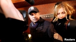 Former Nissan Motor Chairman Carlos Ghosn accompanied by his wife Carole Ghosn, arrives at his place of residence in Tokyo, Japan, March 8, 2019.